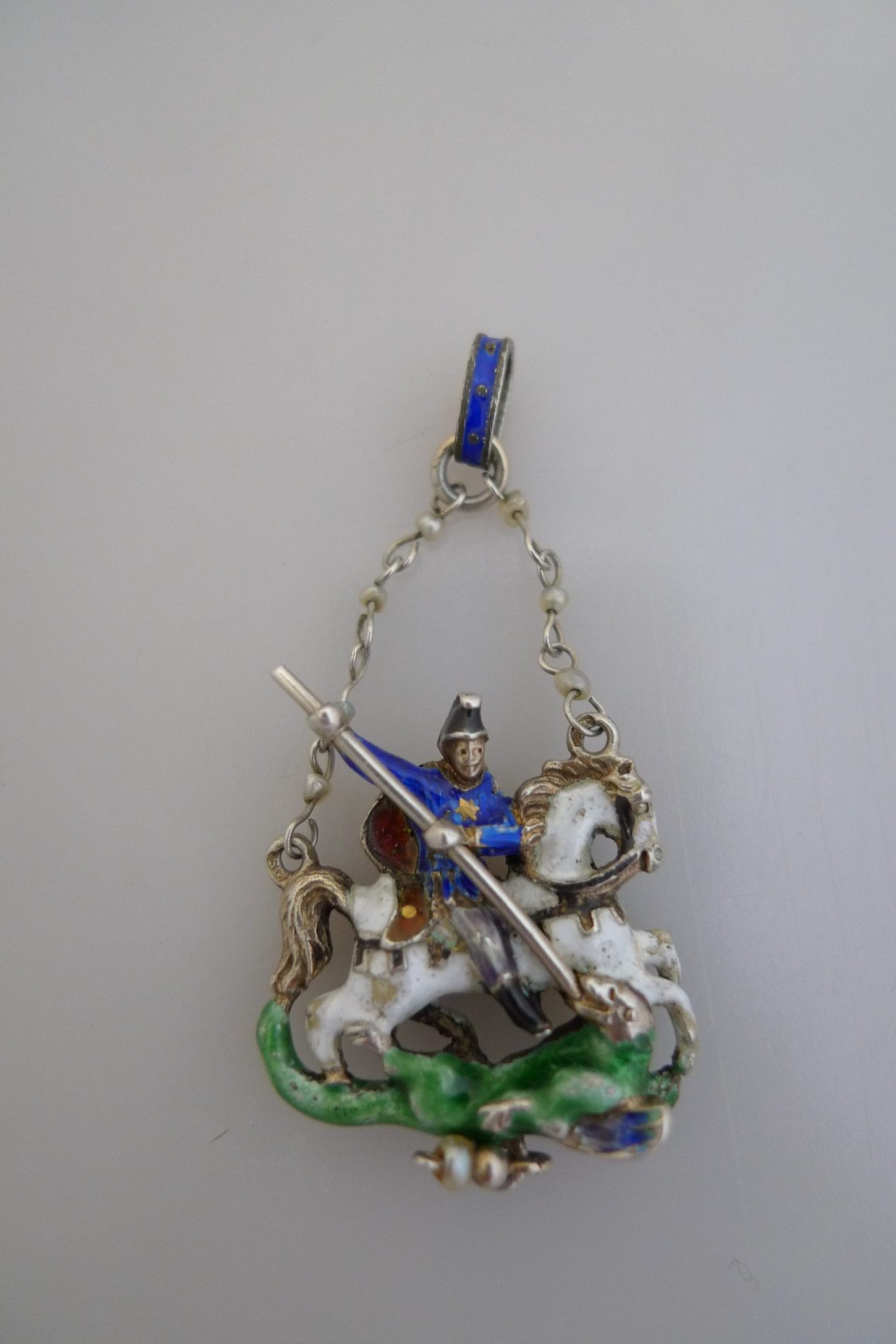 Austro-Hungarian silver and enamel pendant of St. George slaying the Austro-Hungarian silver and enamel pendant of St. George slaying the